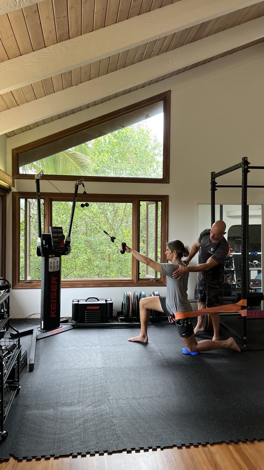 Dan Kayser coaching a client through an exercise at his private Honolulu studio