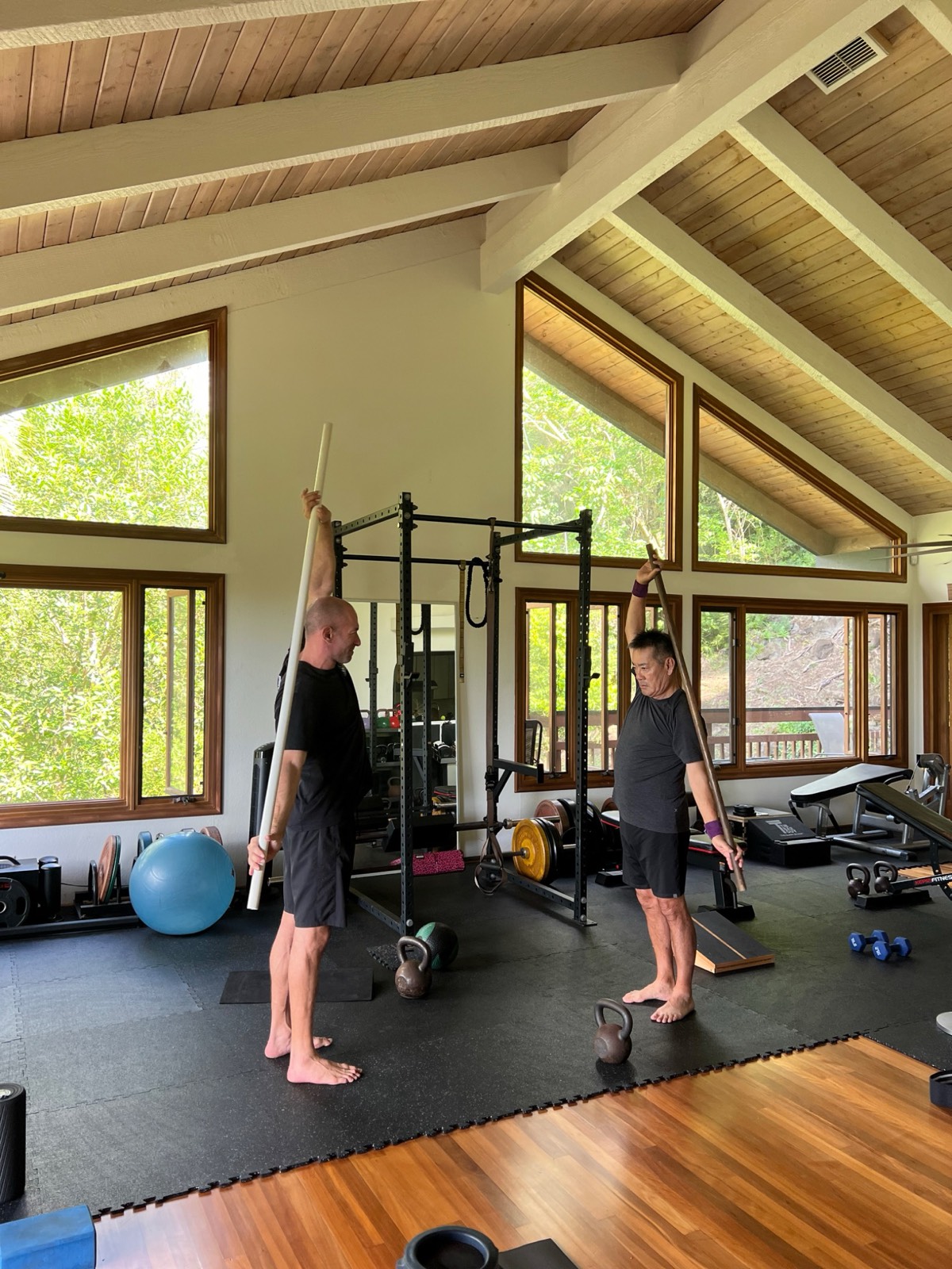 Dan Kayser coaching a client through an exercise in his private Honolulu studio